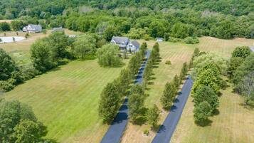 Surrounded by lush greenery, this property offers a serene and environment with a welcoming front porch.