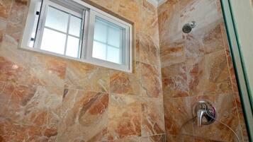 Shower, hair dryer, towels, shampoo