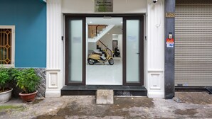A building entrance with a sign for 'Cozyrm Homes Graceful Corner'.