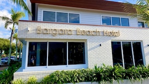A two-story building with a sign reading "Bargara Beach Hotel". - Centrally located "Bargara Beach Cottage" (Bargara)