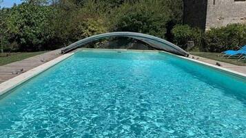 Seasonal outdoor pool, open 9:00 AM to 9:00 PM, pool umbrellas