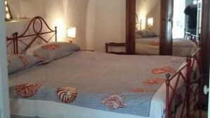 A bedroom with a bed, a wooden headboard, a nightstand, and a mirror. - The Sea - White House (Camporosso)
