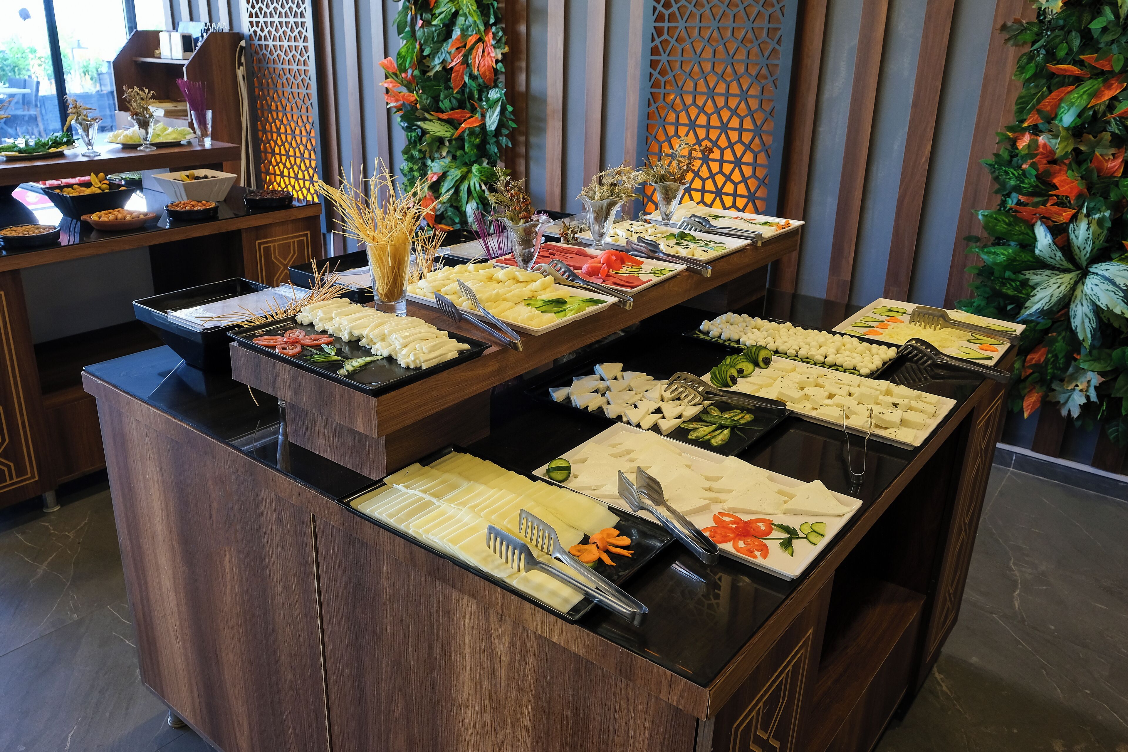 A buffet with various food items and utensils.