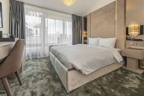 A modern hotel room with a large bed, a desk, and a chair. - St.Palace hotel (Vilnius)