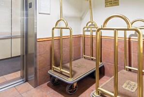 A hotel elevator with a closed door, a wall-mounted sign, and a luggage cart with wheels. - Walk to Lift. Hot Tubs. Elevator. Close to Lake. (Keystone)