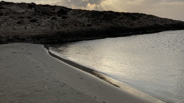 A beach with a sandy shore and a rocky outcrop in the background. - Pardes Villa (Pardes Hanna-Karkur)
