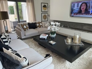 A modern living room with a sofa, coffee table, and decorative items.