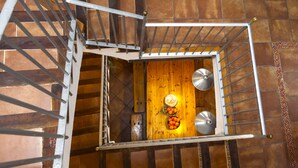 A wooden staircase with metal railings and a white wall at the top. - Ca la Partida (San Rafael del Río)