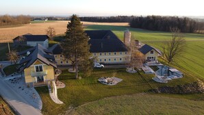 Et stort, flerlænget hus med en rummelig baghave, swimmingpool og en indkørsel.