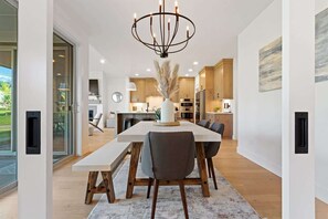 Une cuisine moderne avec des meubles en bois, un îlot central et un lustre.
