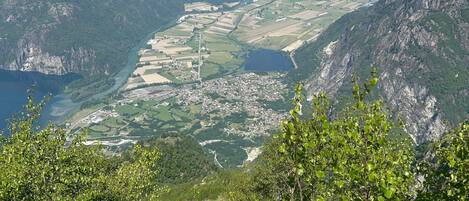 A mountainous landscape with a valley, a river, and a small town.