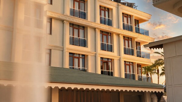Un hotel de varios pisos con balcones, ventanas amplias y un estilo arquitectónico clásico.