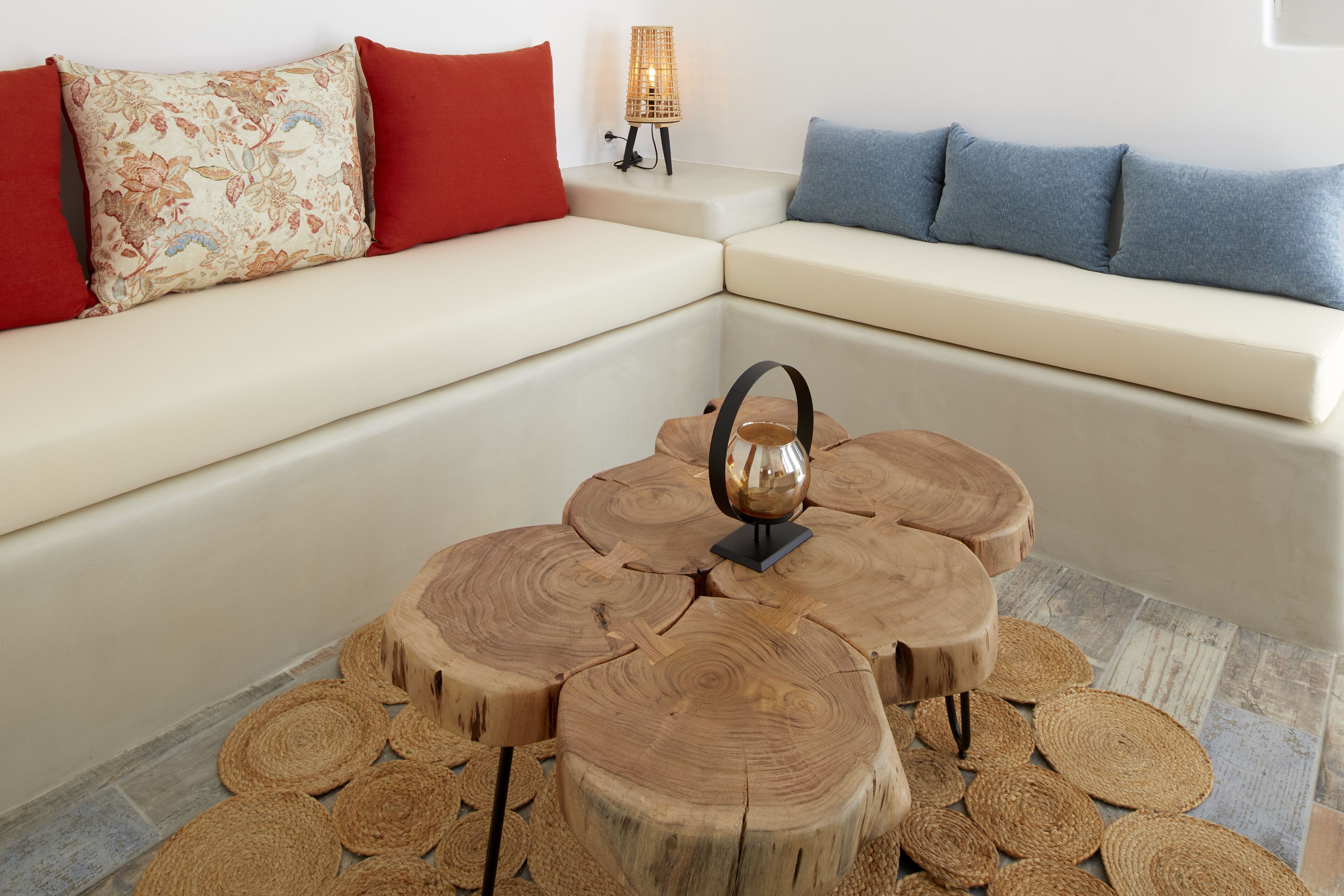 A modern living room with a sectional sofa, a wooden coffee table, and a small floor lamp.