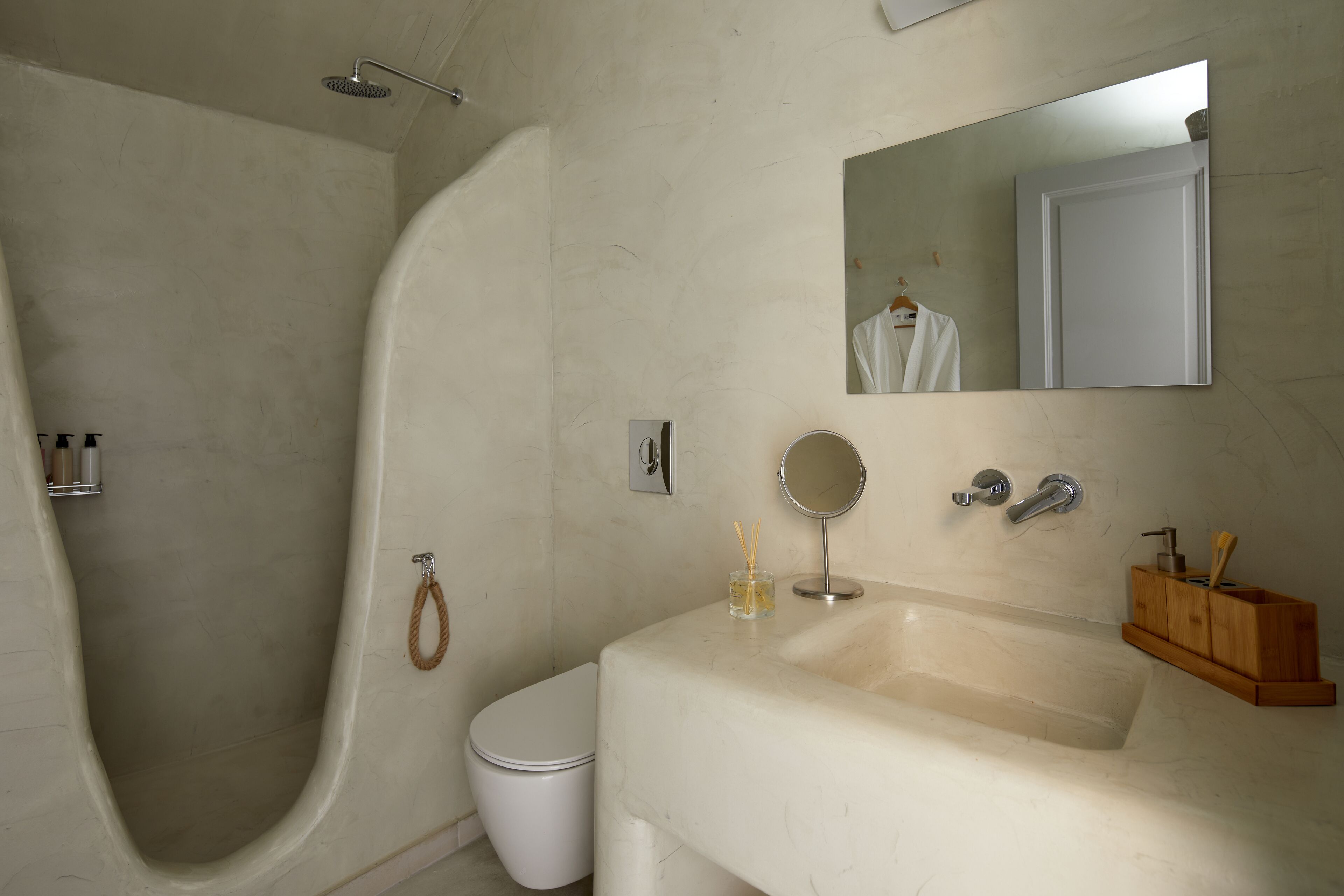 A bathroom with a bathtub, toilet, and a vanity with a mirror and sink.