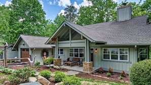 A two-story house with a covered porch, stone pillars, and a landscaped garden. - The Wildcat's Lair: Renovated Home in Highlands w/ Private Deck, Smart Home Tech (Highlands)