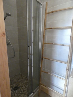 Een douche, handdoeken, toiletpapier