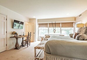 A bedroom with a bed, a desk, a chair, a television, and a window with blinds. - Spacious 5BR estate with Jacuzzi, pool, patio, and full kitchen. (Guntersville)