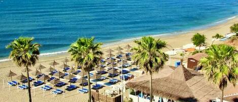 On the beach, sun loungers, beach towels