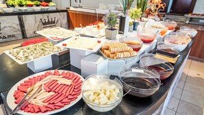 A buffet with various food items including sushi, cheese, and bread rolls. - Castle Park Hotel (Kemer)