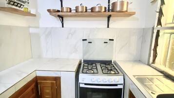 Fridge, stovetop, electric kettle, cookware/dishes/utensils