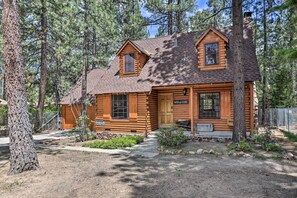 A log cabin with a welcoming sign, a front porch, and a wheelbarrow. - Big Bear Lake Cabin ~ 4 Mi Snow Summit Ski Resort (Big Bear Lake)