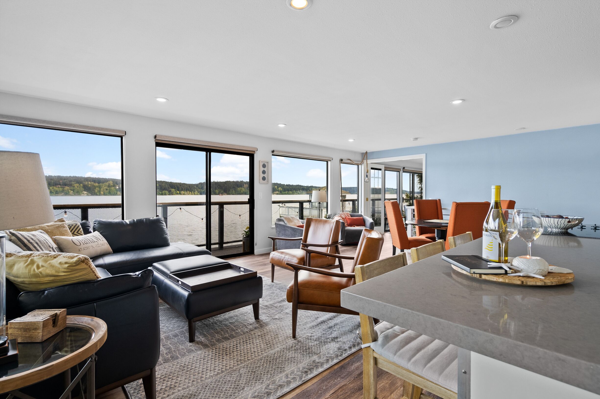 Living room with water view and plenty of seating. 