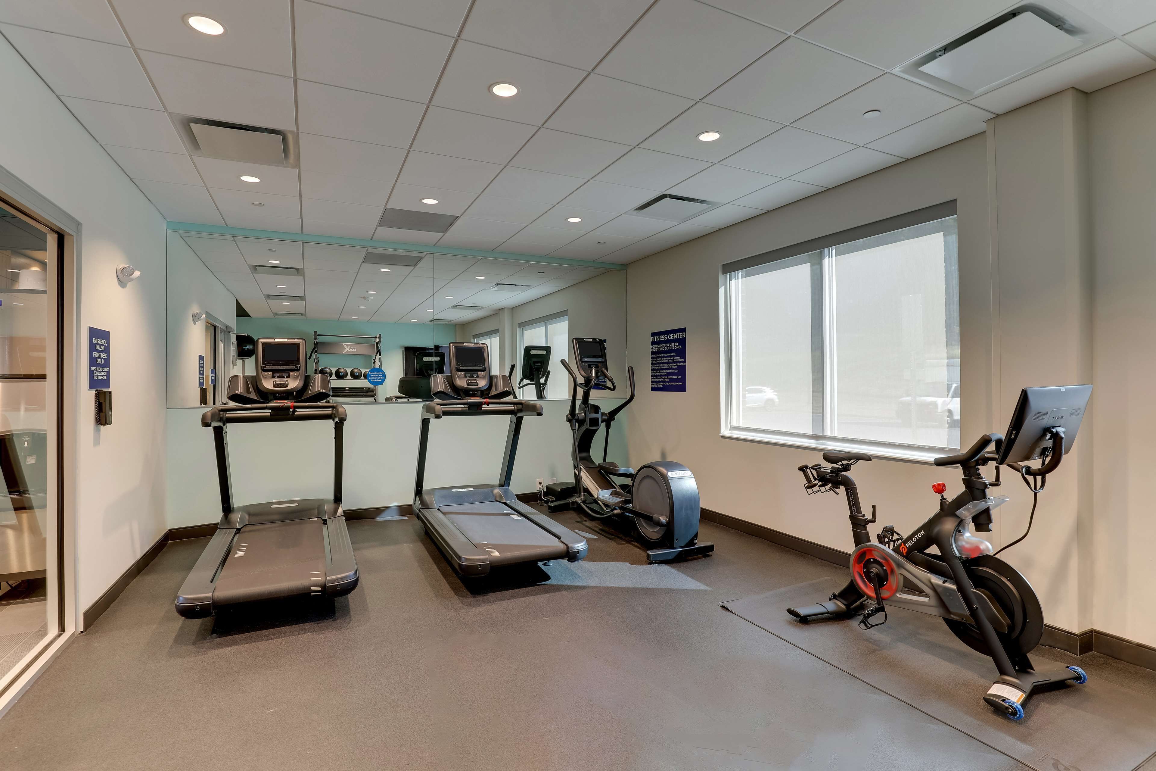 A fitness center with treadmills, elliptical machines, and a stationary bike.
