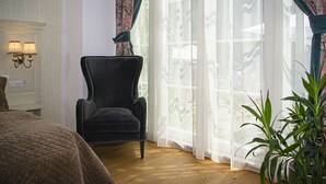 A room with a bed, a chair, a window with sheer curtains, and a potted plant. - Palatul Brukenthal Avrig (Avrig)