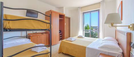 A room with two beds, a wardrobe, a TV, and a balcony with a view.