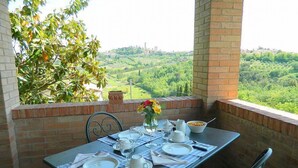 Una tavola imbandita per la colazione con vista su un paesaggio verde.