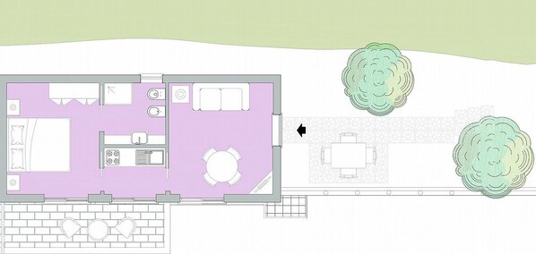 A floor plan of a hotel room with a kitchenette, a dining area, and two green decorative elements.