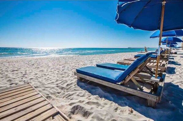 On the beach, sun loungers, beach towels