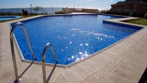 A rectangular swimming pool with a metal ladder on one side, surrounded by a tiled deck. - AP346 TORROX BEACH (Torrox Costa)