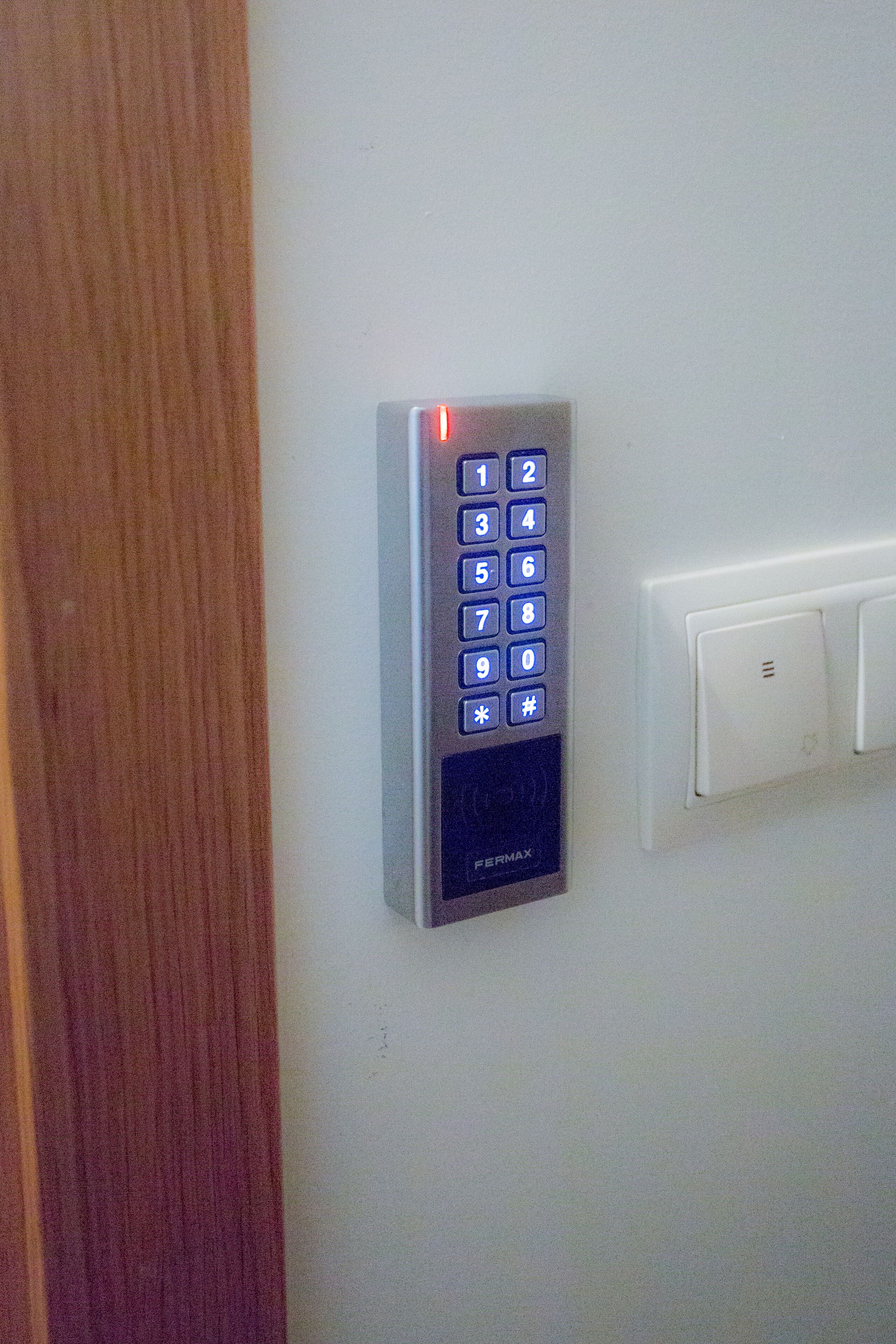 Un clavier électronique fixé au mur, doté d’un pavé numérique et de quelques touches de fonction.