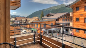 A wooden building with balconies and a mountain view. - Carlina 203 Beautiful ski in ski out 2 bed + cabin  in the heart of the village (MORZINE)