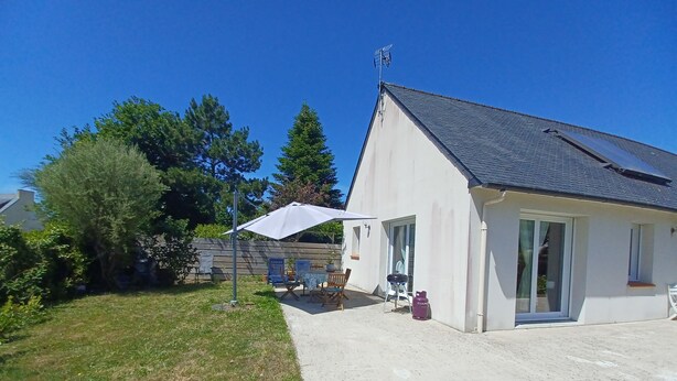 A house with a patio, outdoor furniture, and a satellite dish.