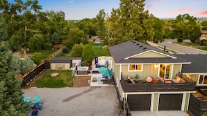 A residential property with a covered patio, a hot tub, and a fenced backyard.