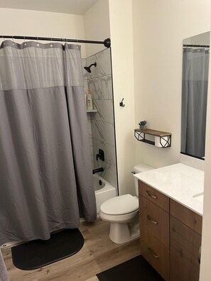 Combined shower/tub, hair dryer, towels, soap