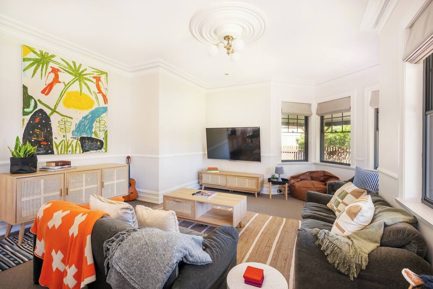  The main living area offers plenty of seating, with two large sofas and a bean bag chair fronting the central TV.