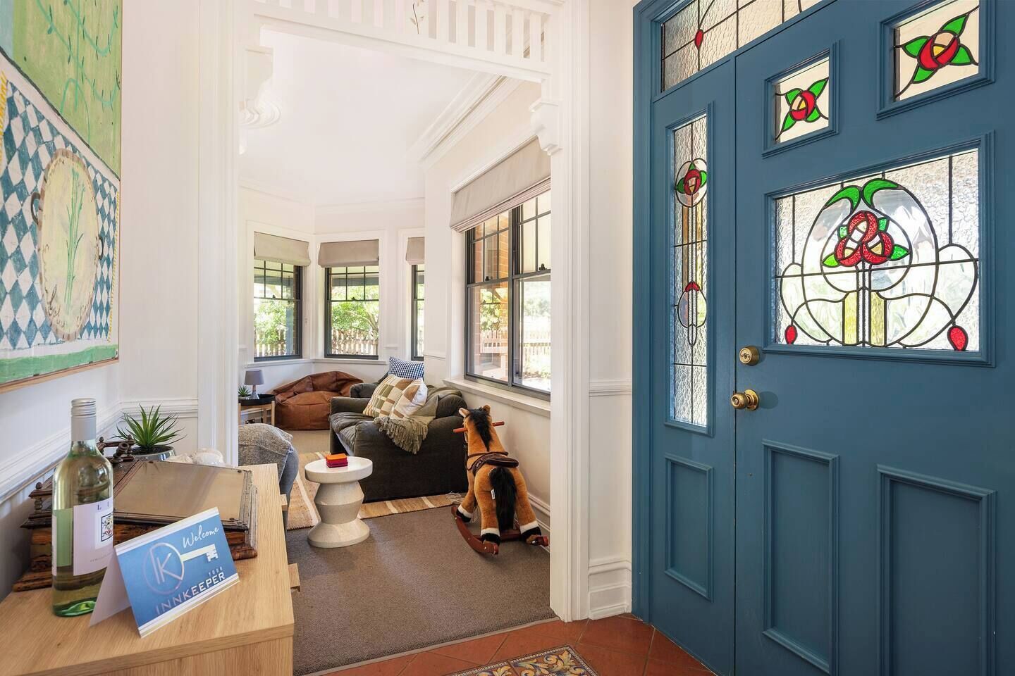 Guests are greeted by a beautiful, stained glass door and colourful artworks at the front entrance.