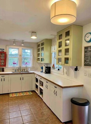 Enjoy a kitchen with a central island, window views, and a wall-mounted clock.