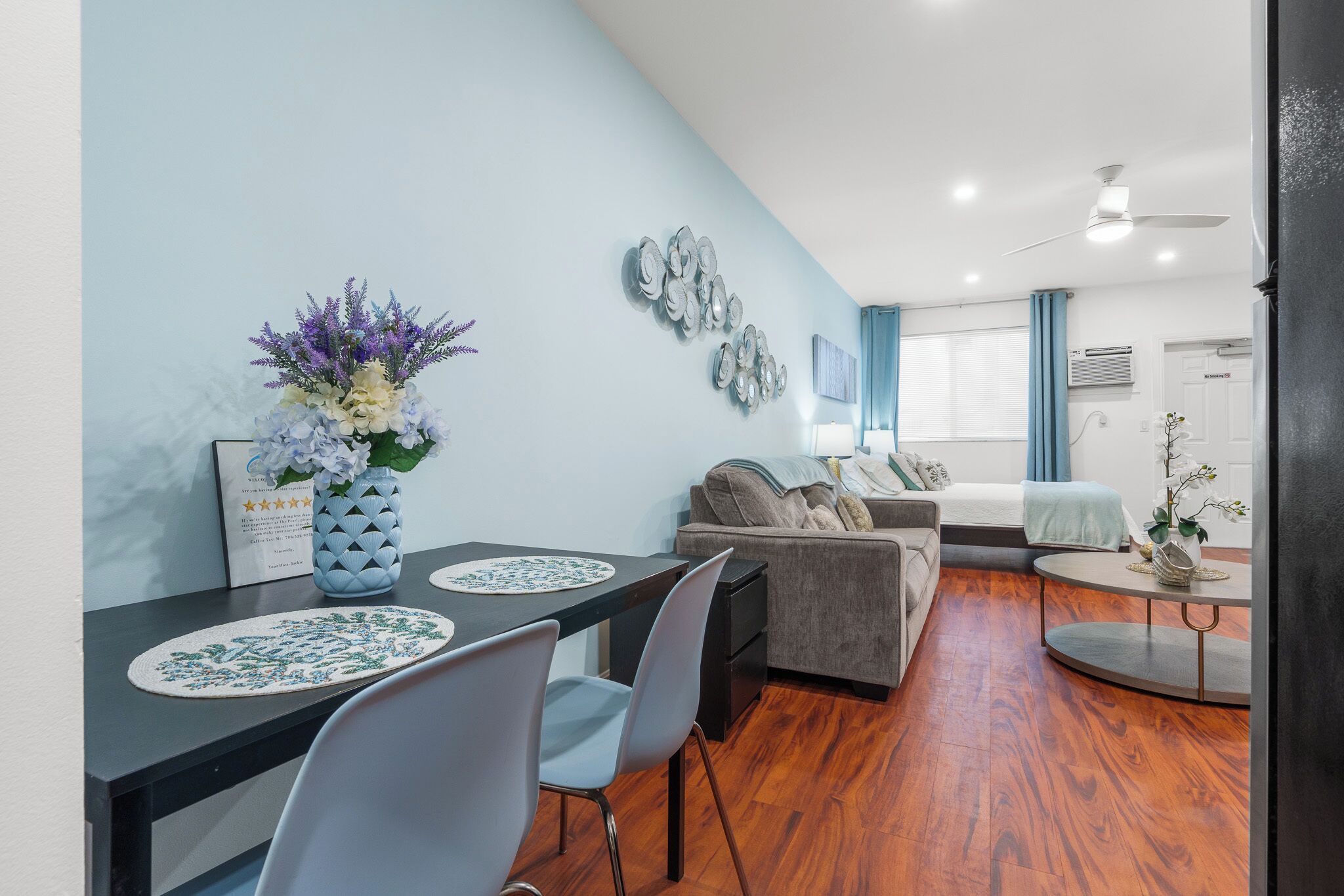 A modern living room with a dining area, a sofa, and a coffee table.