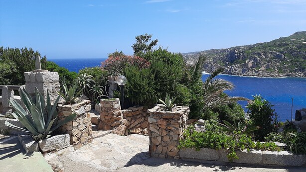 A stone pathway leading to a scenic overlook with a view of the sea and a rocky hillside. - Overlooking the sea Santa Teresa Gallura (Santa Teresa di Gallura)