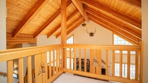 A wooden interior with a high ceiling and a sloped roof. - Sunriver 3 bedroom home, new hot tub, 8 SHARC passes (Sunriver)