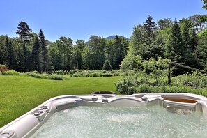 Relax in the outdoor hot tub with summit views of Pico Mountain