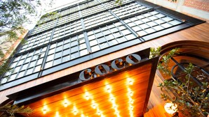 A building with a prominent 'Coco' sign, large windows, and a wooden facade. - Hotel Coco (Bogotá)