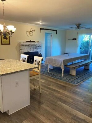 Cozy living space with a kitchen, dining area, and access to an outdoor space.