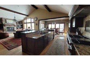 Enjoy cooking in this well-equipped kitchen with a large island, stove, and ample counter space.