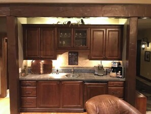 Enjoy cooking in this well-equipped kitchen with a stainless steel sink, coffee maker, and various appliances.