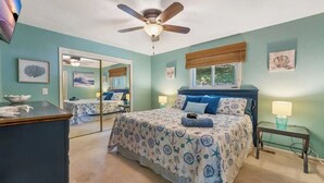 A bedroom with a bed, bedside tables, a ceiling fan, and a window with blinds. - Quiet Lakefront - Hot Tub! H2O Toys! Pet Friendly! (Linn Creek)